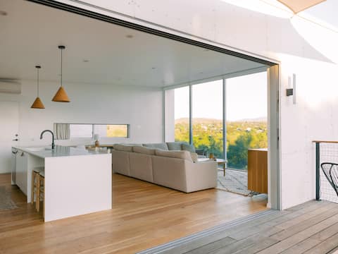 A modern light-filled home with views of the woods