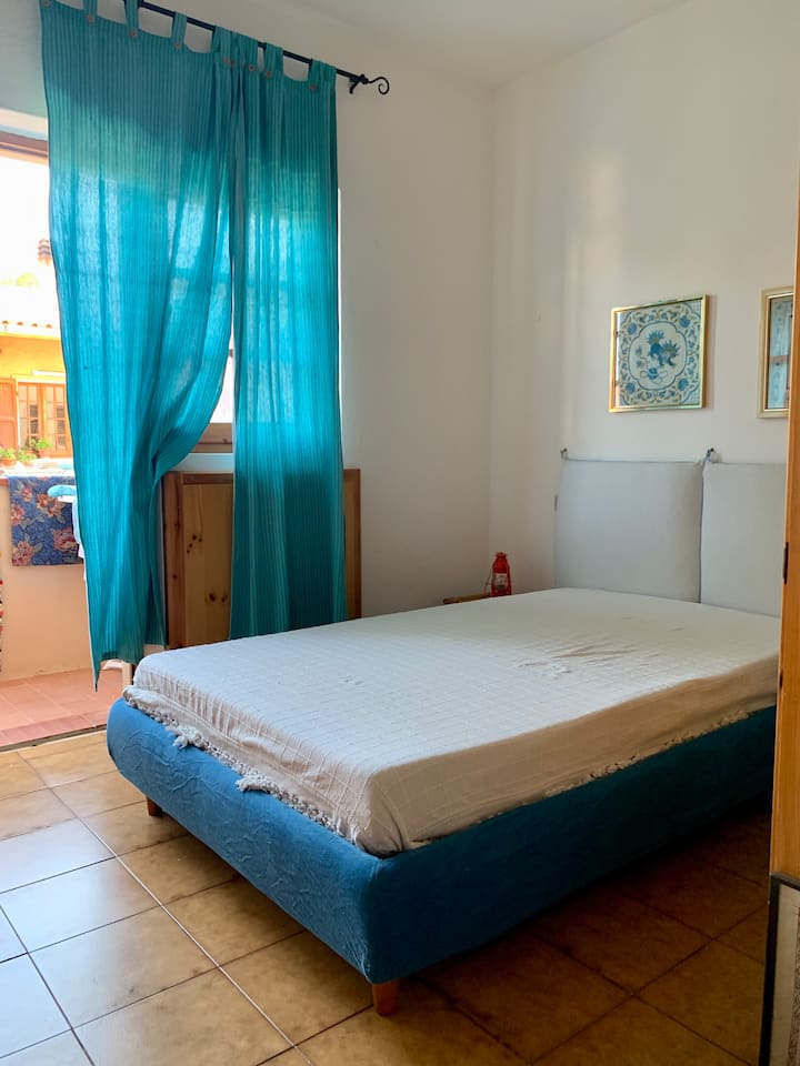 Spavaća soba s bračnim krevetom i pol s prozorom i prozorom na terasi