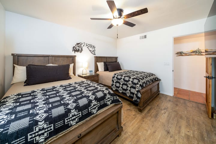 Our "Two Wolves" bedroom offers TWO Revive H2 Firm Hybrid full beds, which may accommodate two to four guests, depending on size and preference. 

Enjoy comfortable bedding and cushiony pillows! Luggage stands are also provided in the bedrooms. 