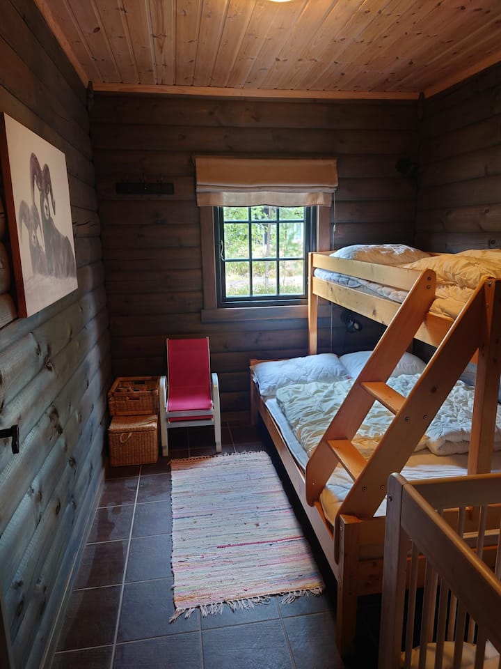 Spálňa 2 s rodinnou posteľou  (120 m x 200 m, 70 cm x 200 cm) a detskou postieľkou pre malé dieťa.