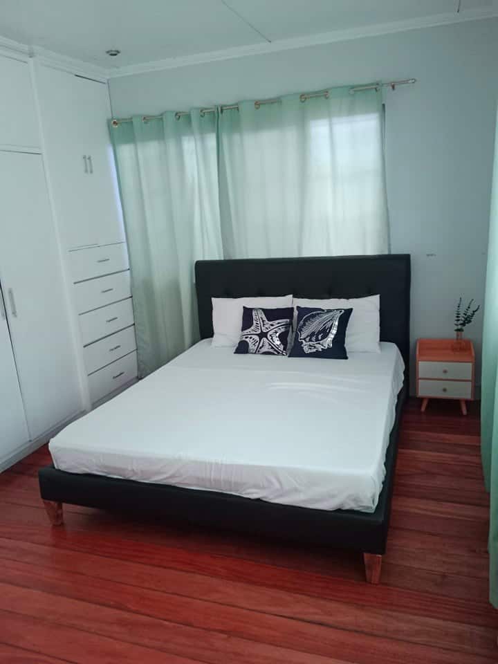 Bedroom 3 is equipped with a queen-sized bed and an additional queen-sized mattress, comfortably accommodating up to four guests. 