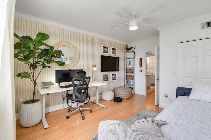 Your productive workspace awaits! Combination second bedroom/office with standing desk, ergonomic chair, monitor, meditation cushions, and Smart TV.