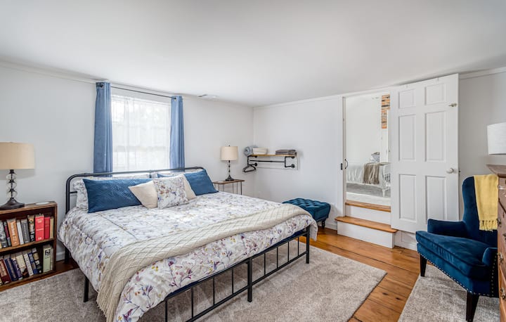 King bedroom #2!  
Note the steps up to the queen room.
Closets weren't common in homes from the 1850's so we've been lovingly selecting antique dressers and installing industrial piping/shelving for guests to store their belongings!