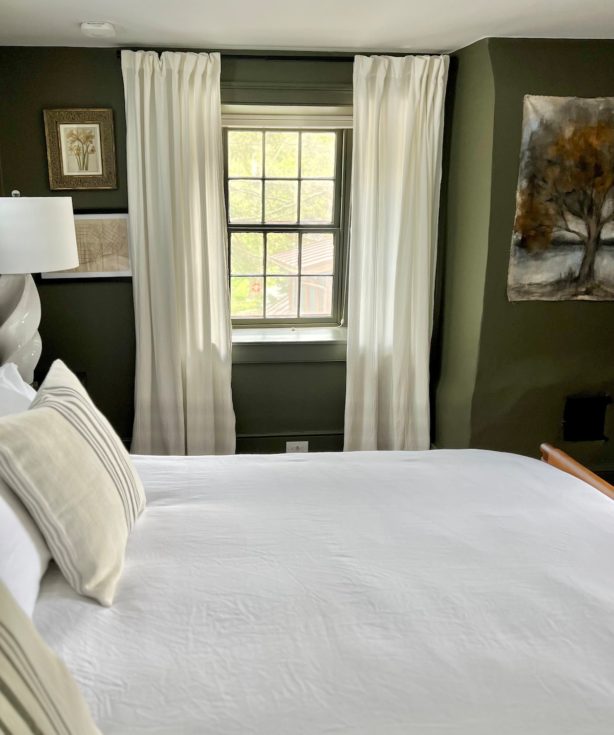 ~General Store~
Escape to the luxurious primary suite with dark moody walls and a luxe leather king size bed.  Enjoy the custom painting by artist Lauren Rose Jackson.