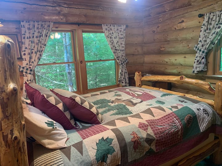 This is the master bedroom to the left with  two big windows showing into the forest. Annexed to it is a newly done bathroom with double shower.