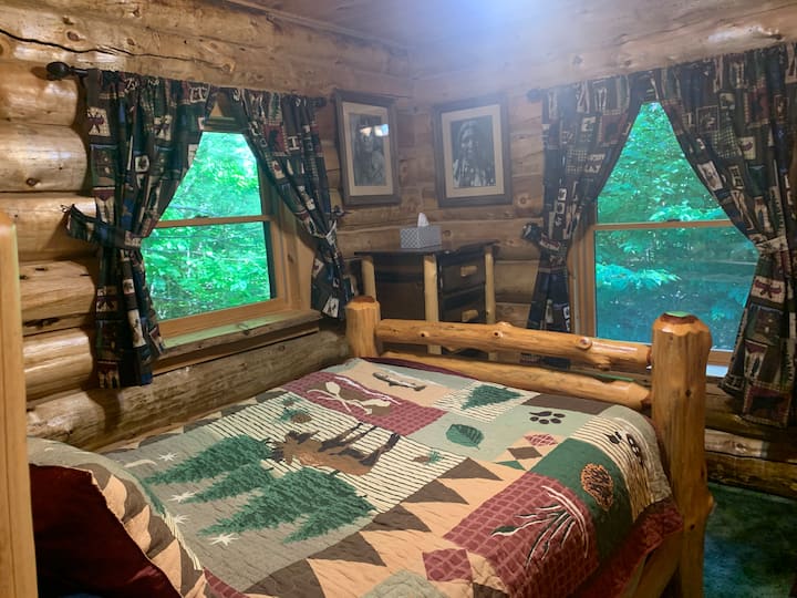 This is the first guestroom to the right on the first floor with two big windows showing into the forest.