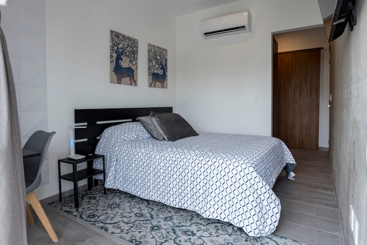 ห้องรองพร้อมเตียงควีนไซส์โคมไฟพร้อมที่ชาร์จไร้สายและเครื่องปรับอากาศ