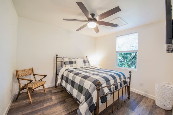 The small house has a single queen bed just off the dining/kitchen.