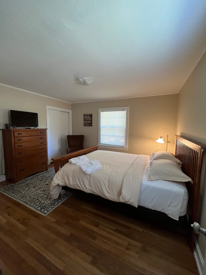 Spacious Master Bedroom with Queen Bed and Roku Smart TV.