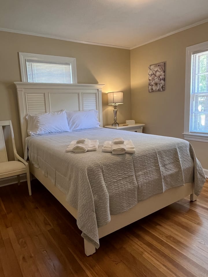 Bright, inviting room with Queen Size bed and huge wall closet opposite the bed.