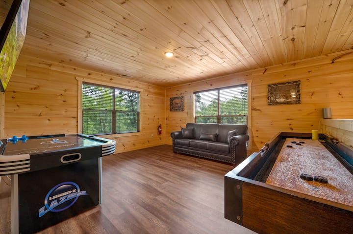The loft area features a queen-size sleeper sofa, Air Hockey game, Shuffleboard game, and a 2-person seated multicade arcade(not pictured). Perfect for spending some time at the cabin after a day of visiting the attractions in Pigeon Forge.