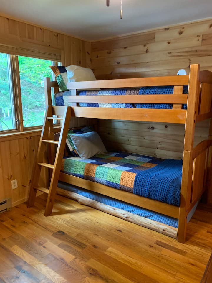 3 twin beds, bunks + a trundle.  Can see lake out window.  Dresser, nightstand, clock