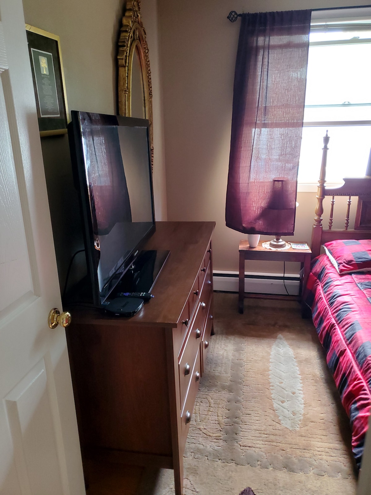 Rear bedroom with queen bed, ceiling fan and Roku TV