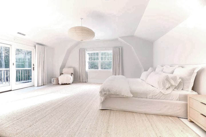 Primary bedroom. Balcony overlooks pool and east side of backyard.