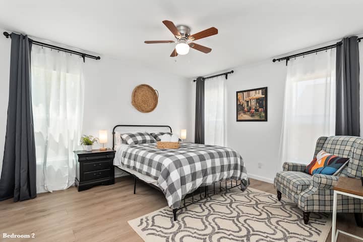 Slip into dreamland within the soft embrace of the downstairs Queen bedroom, where blackout curtains stand guard against the morning sun. 