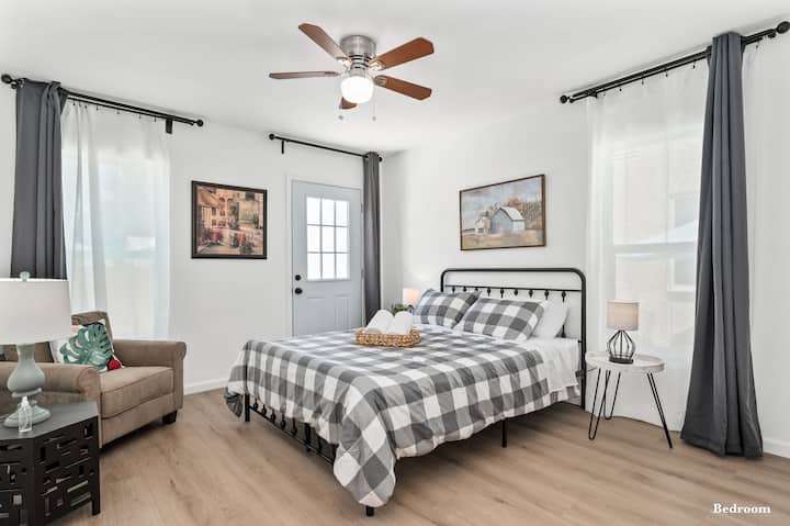 The second downstairs Queen bedroom, adorned with dual nightstands, an armchair, and a 40” LED HDTV to satisfy all of your viewing needs.