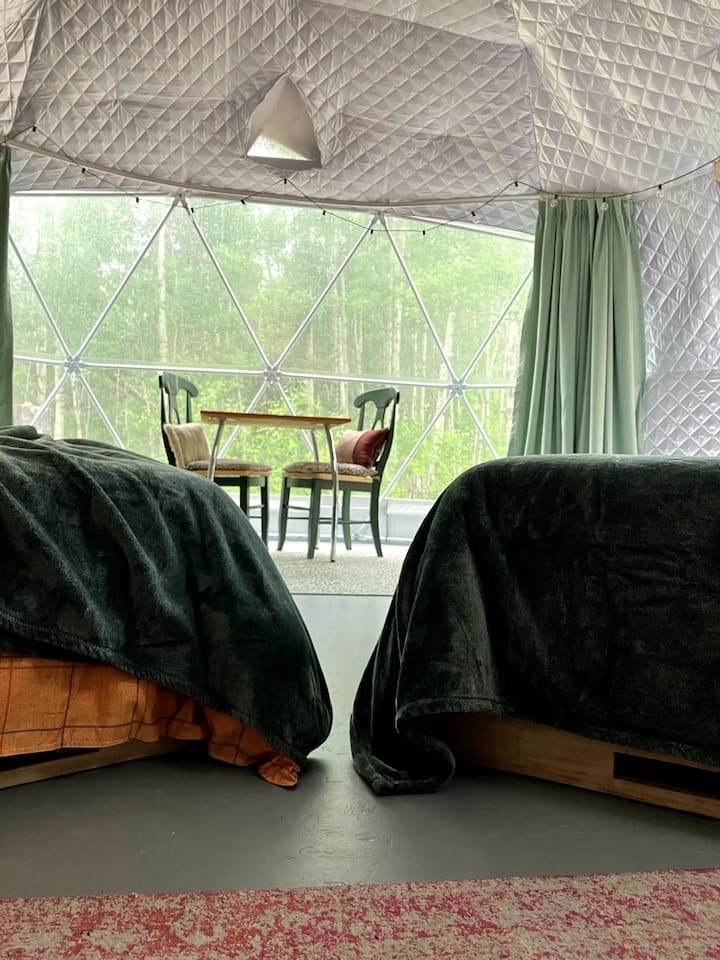 There is lots of space for two cozy Queen beds and seating to enjoy the forest views from the panoramic window. Maybe a momma deer and her baby will wander by!