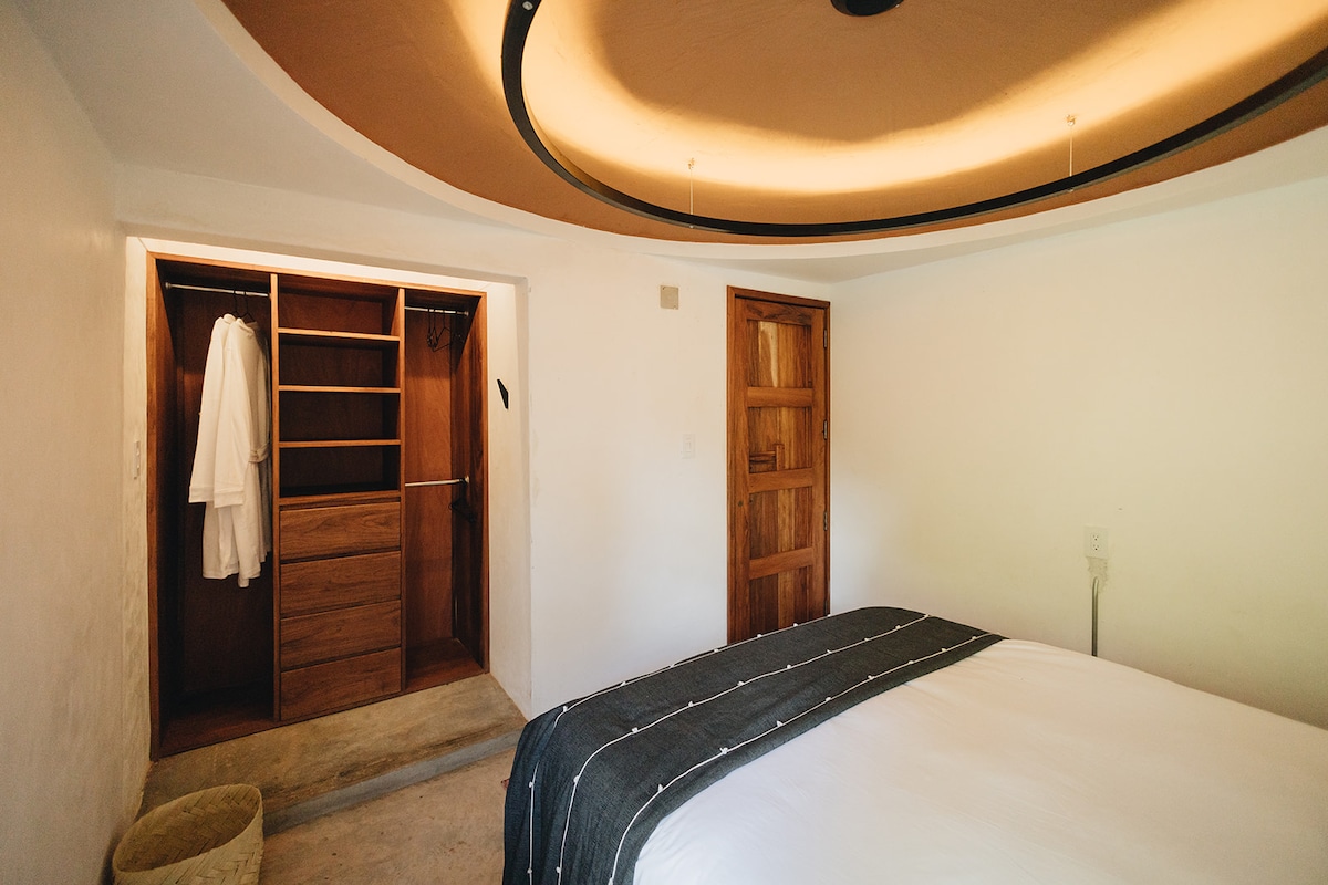 Two bathrobes hang from the built-in closet. Door lock from the inside with a traditional wooden sliding lock for privacy. 