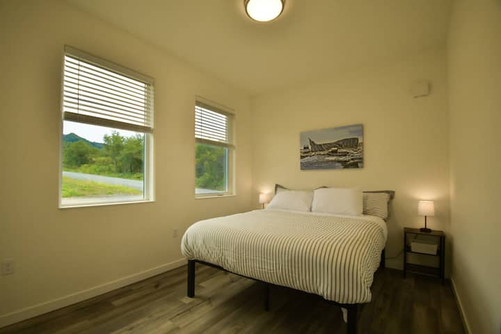 Roomy guest bedroom with original artwork.