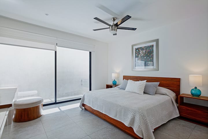 This bedroom is located at the front of the home.  It is designed to be protected from the sunshine that hits the front of the house in the afternoon.  Features a balcony that faces the pool area where you can enjoy your morning coffee