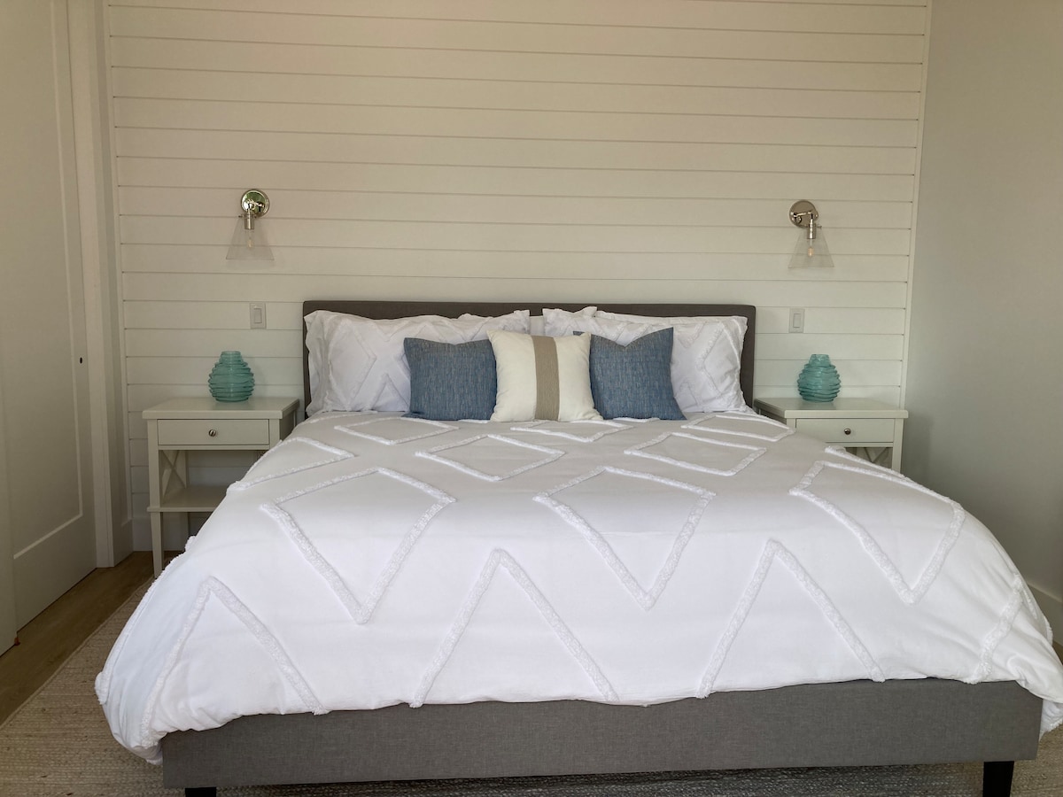 King size bed in the master facing patio door which leads out to the deck.