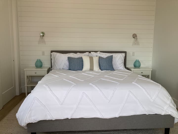 King size bed in the master facing patio door which leads out to the deck.