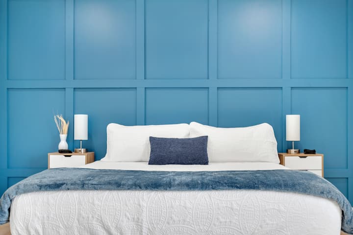 Bedroom 1: Master bedroom with premium king-size bed and blue accent wall. Includes a walk-in closet and 1 full restroom.