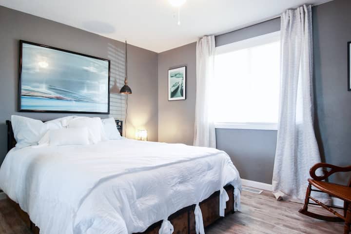 Bedroom 1 features a queen Stearns & Foster mattress on a platform bed with built-in USB ports, along with two bedside tables- each with USB charging ports. The room also includes a dresser & two full-size closets, providing plenty of storage. 