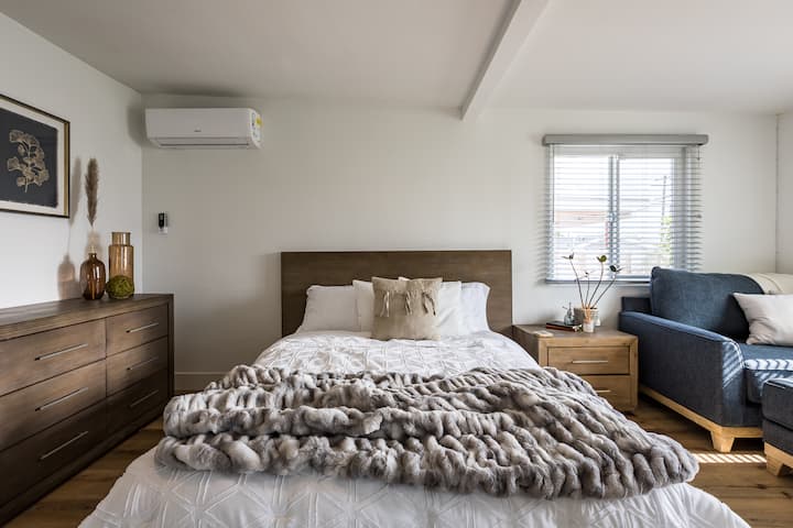 Მთავარი საძინებელი ორადგილიანი საწოლით, დიდი ზომის შეზლონგით და ცოცხალი რეზინის ხით.