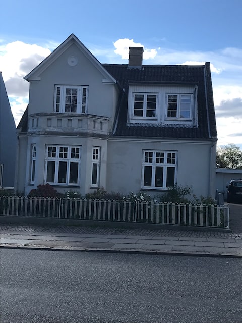 Large city house close to the pedestrian street and the water.