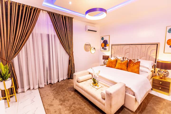 Une chambre paisible avec un lit moelleux et des draps frais, un éclairage doux et un décor de bon goût. Les tons chauds et l'ameublement élégant créent un havre de paix, parfait pour se reposer et se détendre après une longue journée.