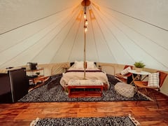 A+luxurious+glamping+tent+nestled+in+the+trees.