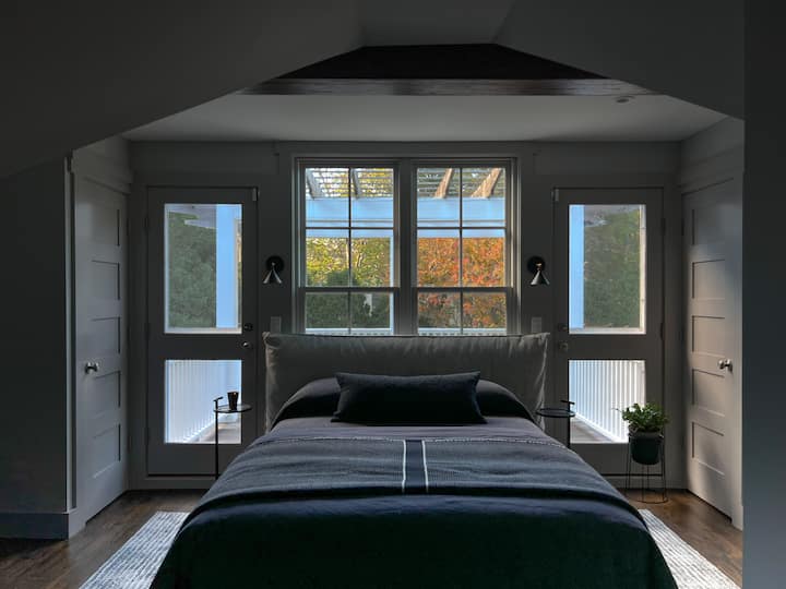 Master bedroom, on the second floor, with a private outdoor deck.