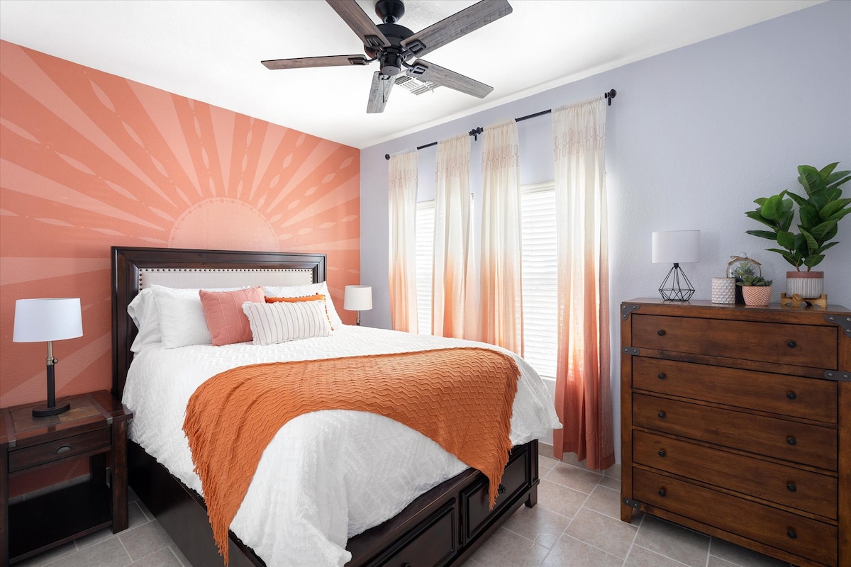 The sunrise room is on the first floor and features this creative and colorful mural by your host, Julie, with an elegant, tall, queen-sized bed. 