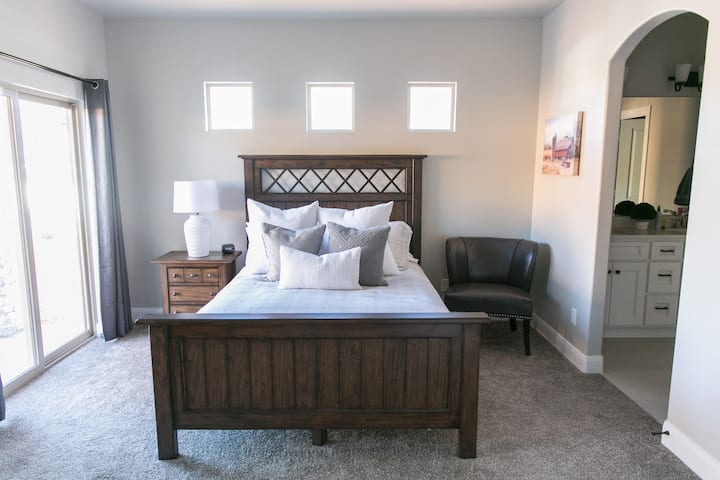 Master Suite #1 on the main floor, right off of the kitchen. Perfect for late night snaking ;). Enjoy a private patio and a private bathroom. 