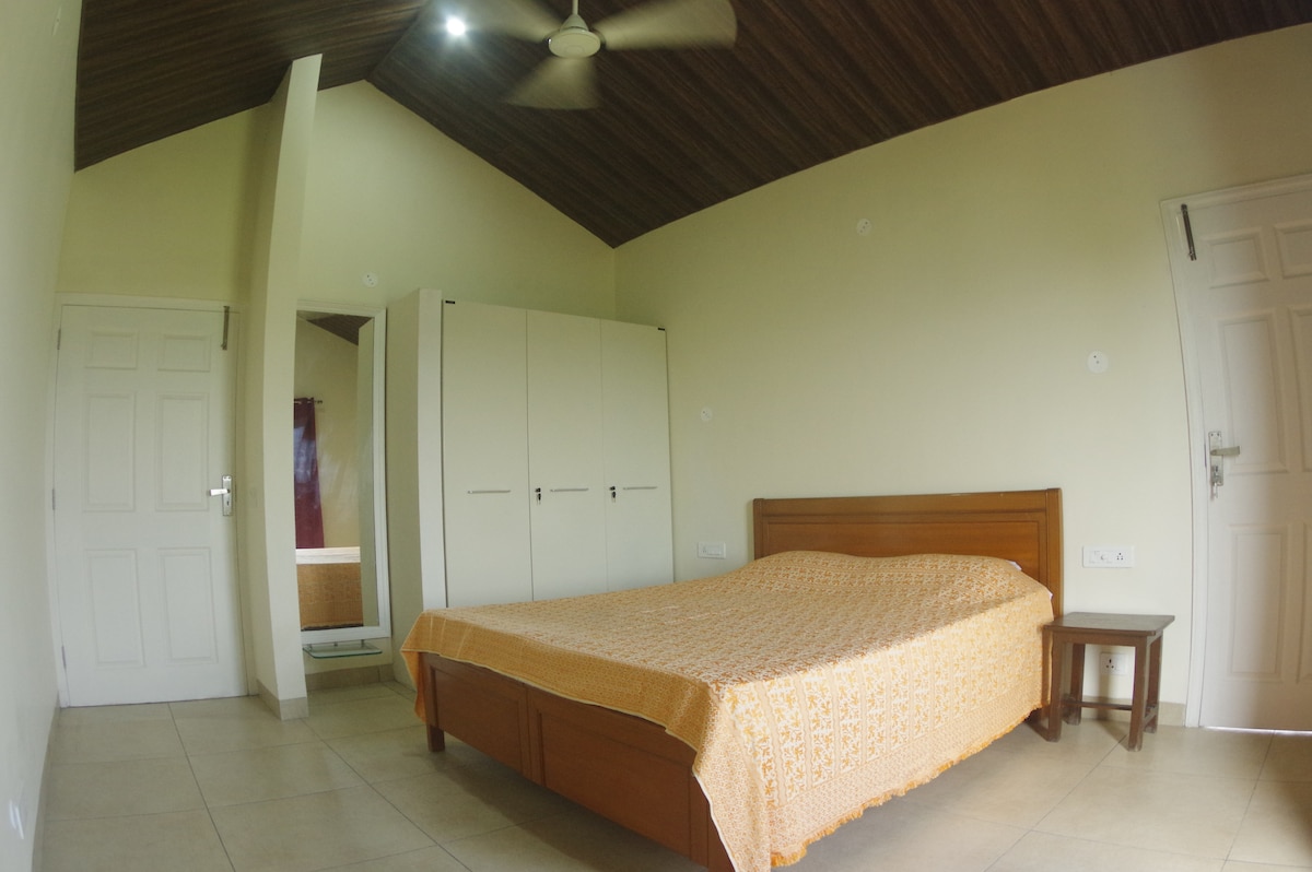 Spacious bedroom with dressing area and steel cabinets with built in safe.