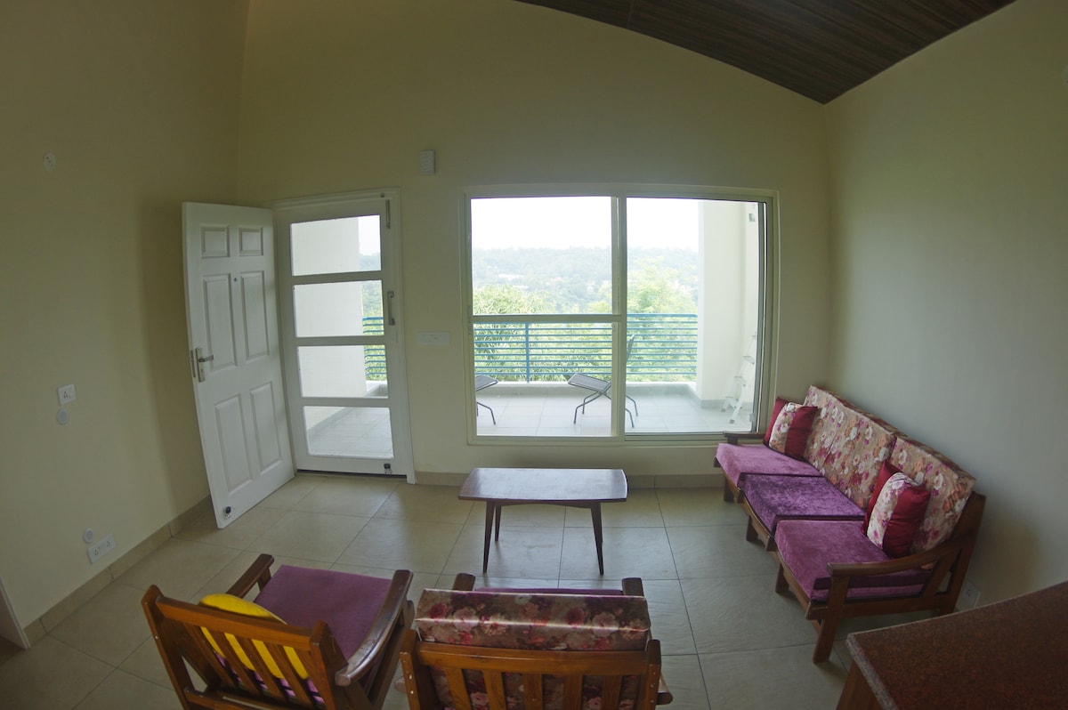 Living area with a large covered patio and breathtaking view.