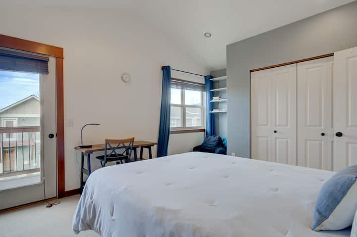 This is the master bedroom which features a second floor balcony with Bridger Mountain views, a workspace, an attached Jack'n'Jill full bathroom, plenty of storage, queen bed, ceiling fan, and a cozy mattress!