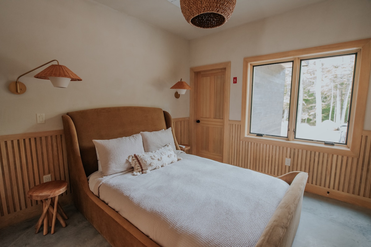 Guest bedroom with a queen bed. All furniture and lighting from Arhaus 