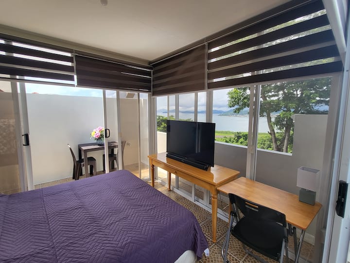 Our Ohana Abode upstairs bedroom is equipped with a queen sized bed, TV, Aircon, fan. There's also a full workstation with a view for the ultimate relaxation/inspiration!