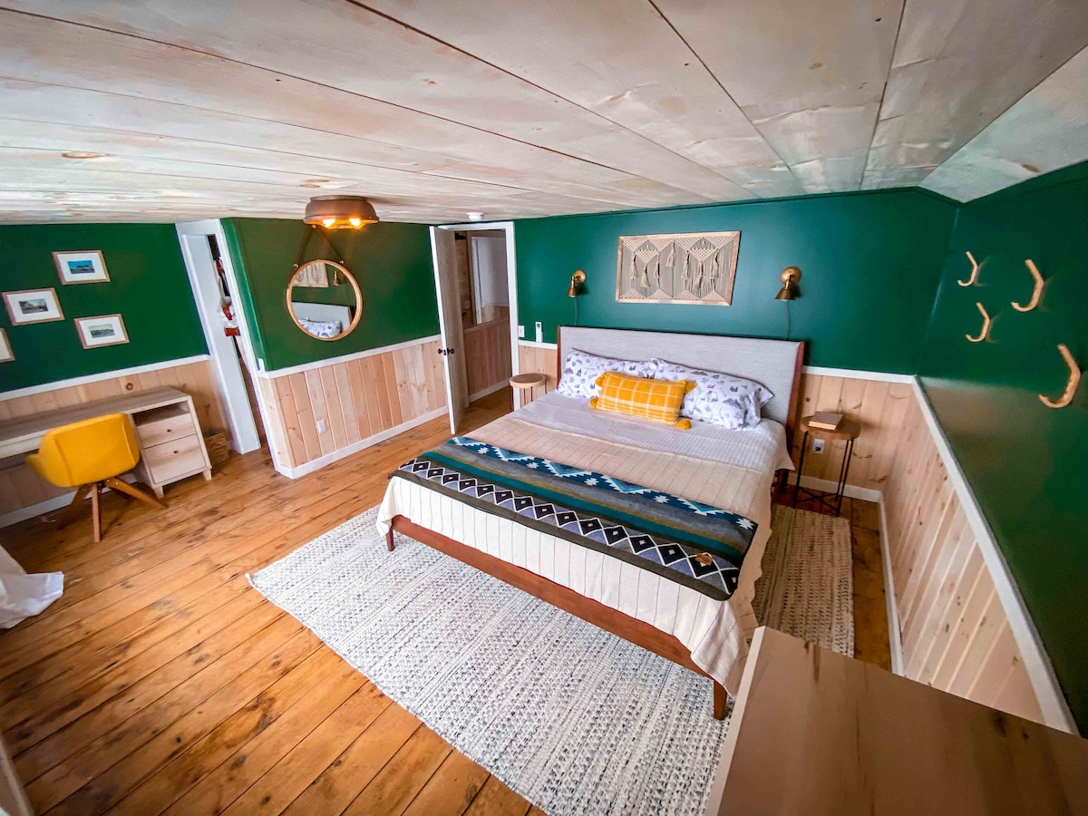 The primary bedroom is on the second floor with a king bed and water views. 