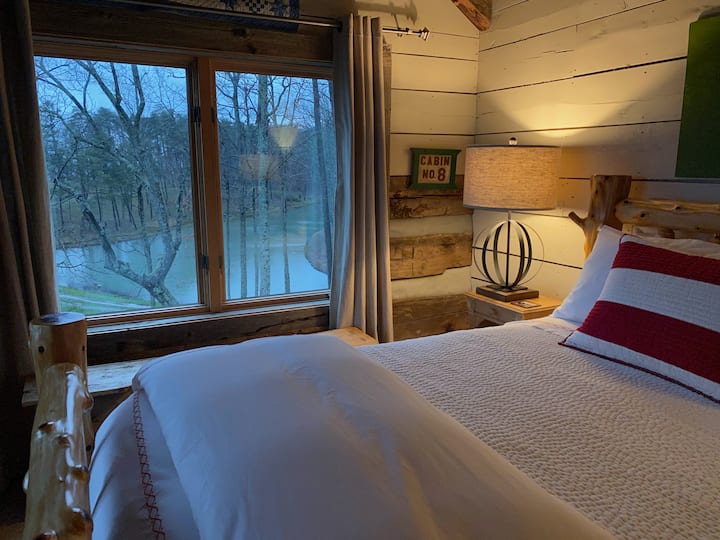 queen bedroom upstairs at the cabin overlooking the pond and has a beautiful view off the mountain too!