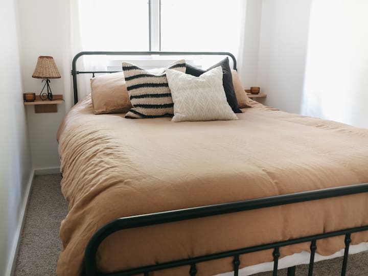 Second floor bedroom with queen memory foam mattress, black metal bed frame and handmade floating night stands. Ceiling fan to keep you cool during those warmer days. Cozy and calm, with plenty of space to rest after a day exploring