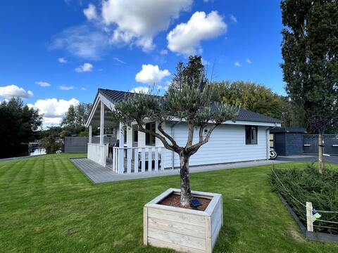 Charming chalet on pond in wooded area.
