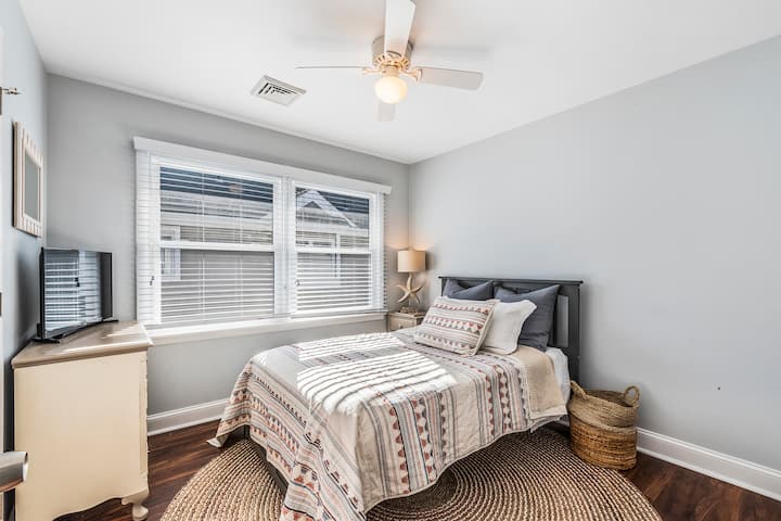 غرفة نوم بسرير مزدوج وسرير متحرك واحد. يوجد تلفاز في الغرفة.