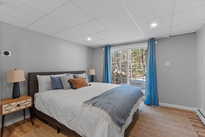 Bedroom on the lower level with a walk out sliding door leading to the lower driveway. This bedroom has one King size bed.