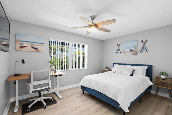 Queen Bedroom with adjustable standing desk and TV. Perfect for work or relaxation!