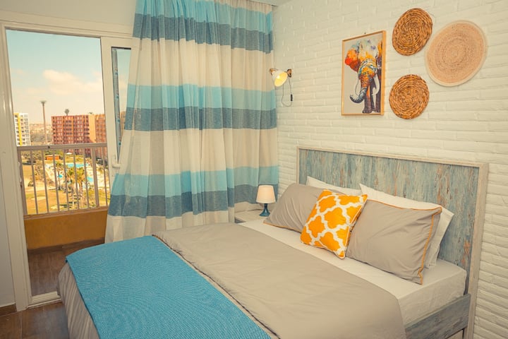 "Cozy bedroom in the heart of the city, Enjoy a comfortable queen-sized bed, ample natural light, and modern decor. Relax and unwind after a day of exploring the city's attractions."