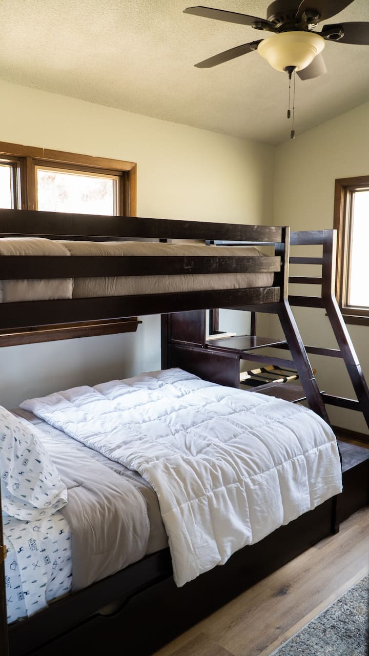 Second bedroom upstairs. Triple bunk bed - top/twin, main/full, trundle/twin.  Room includes built in desk/work nook.