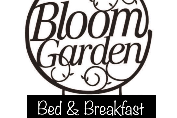 The Bloom Garden Bed & Breakfast logo is displayed prominently, featuring elegant lettering in a circular design. The words 'Bloom Garden' are accentuated above a solid black panel stating 'Bed & Breakfast,' reflecting the welcoming identity of the establishment.